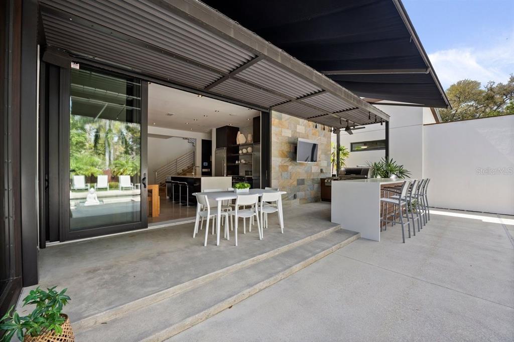 1411 Nottingham Street Orlando, FL 32803 - Photo 35 of 47 a view of a patio with table and chairs and potted plants