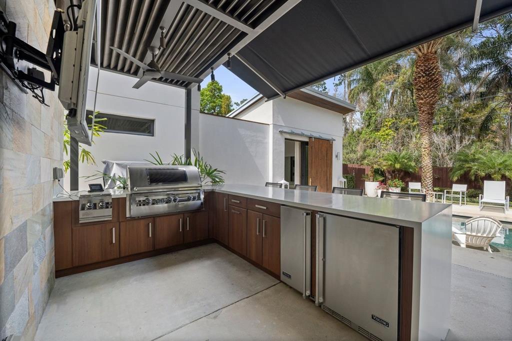1411 Nottingham Street Orlando, FL 32803 - Photo 37 of 47 a kitchen with stainless steel appliances granite countertop a sink and stove top oven