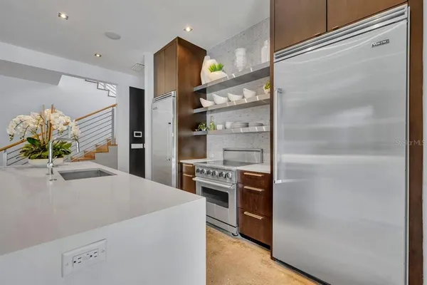 a kitchen with a refrigerator and a stove