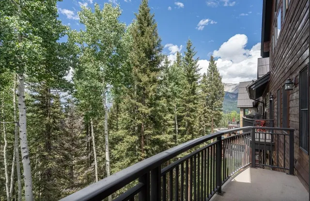 a living room with furniture a rug and a fireplace