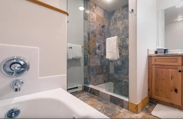 a bedroom with furniture and a flat screen tv