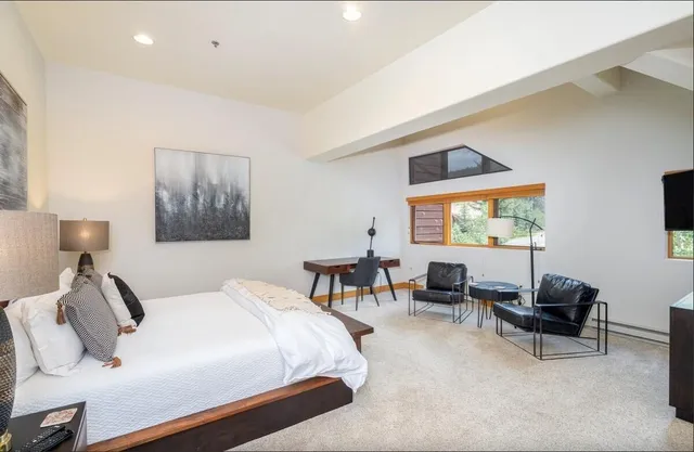 a bedroom with a bed and a couch