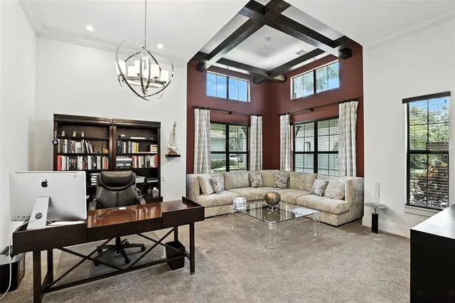 a dining room with furniture a chandelier and wooden floor