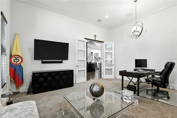 a kitchen with stainless steel appliances kitchen island granite countertop a refrigerator a stove a microwave oven a dining table and chairs with wooden floor