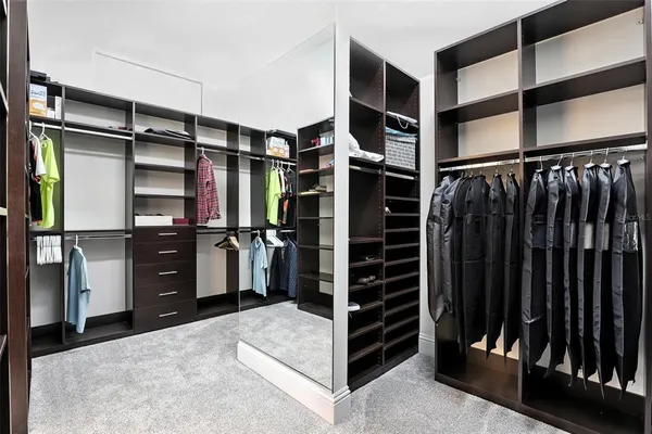 a living room with patio furniture and a floor to ceiling window