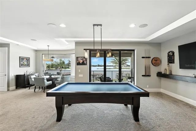 a front view of a house with swimming pool having outdoor seating