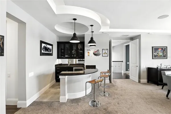 a front view of multiple houses with yard and green space