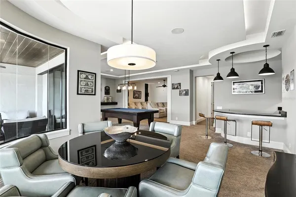 a view of a chairs and table in the balcony