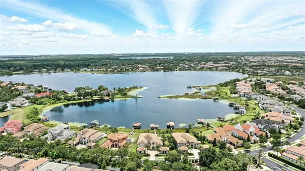 a kitchen with stainless steel appliances kitchen island granite countertop a stove and a view of living room