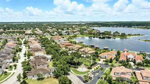 a living room with furniture large window and chandelier