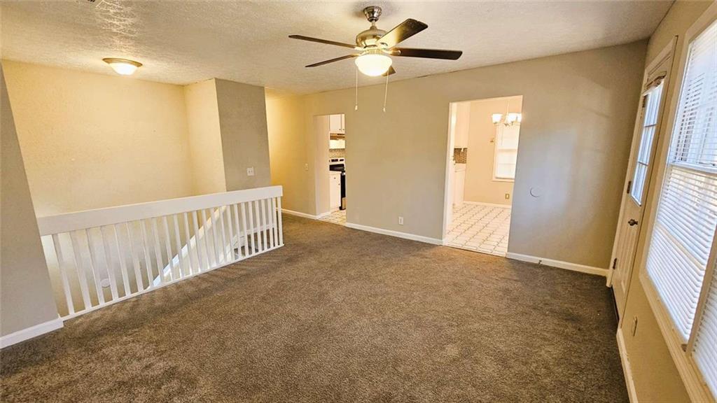 2172 Nancy Way Loganville, GA 30052 - Photo 12 of 21 a view of a hallway with a chandelier fan and a livingroom