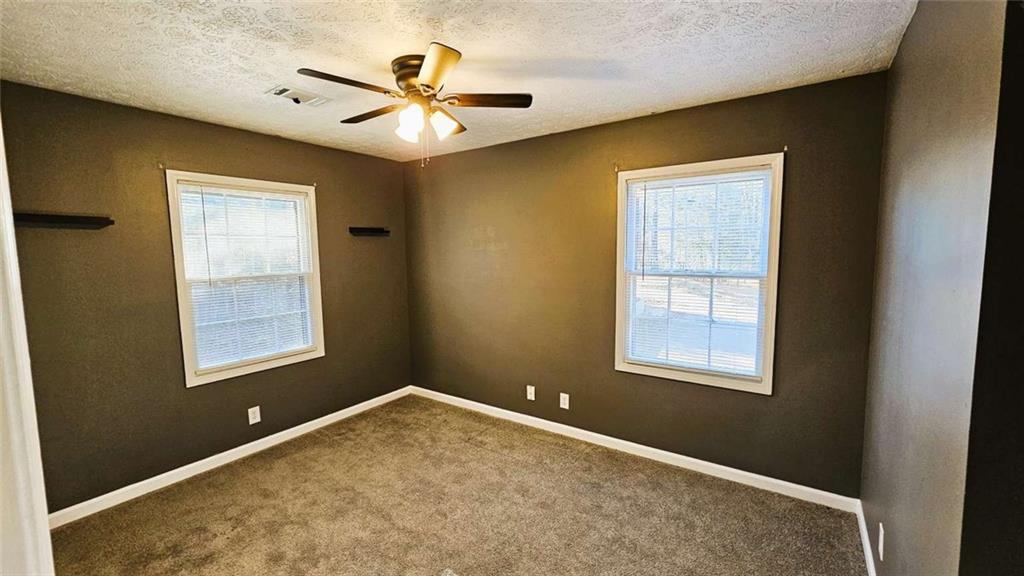 2172 Nancy Way Loganville, GA 30052 - Photo 18 of 21 a view of an empty room with a window