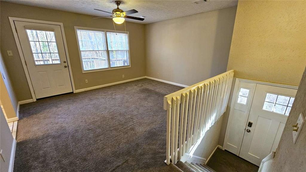 2172 Nancy Way Loganville, GA 30052 - Photo 3 of 21 wooden floor in an empty room with a window