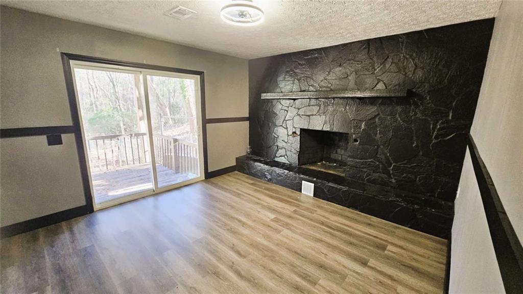 2172 Nancy Way Loganville, GA 30052 - Photo 5 of 21 a view of empty room with wooden floor and fireplace
