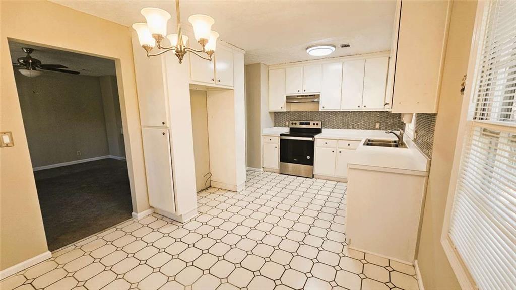 2172 Nancy Way Loganville, GA 30052 - Photo 8 of 21 a kitchen with stainless steel appliances a refrigerator sink and cabinets