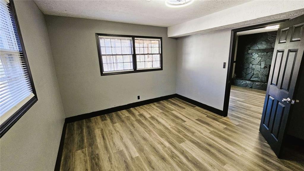 2172 Nancy Way Loganville, GA 30052 - Photo 10 of 21 a view of an empty room with wooden floor and a window