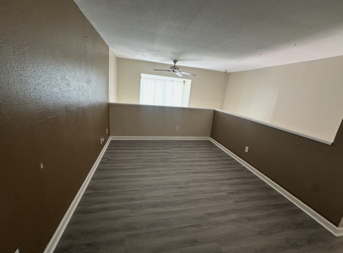 16120 Stuebner Airline Road, Unit 202 Spring, TX 77379 - Photo 8 of 12 an empty room with wooden floor and windows