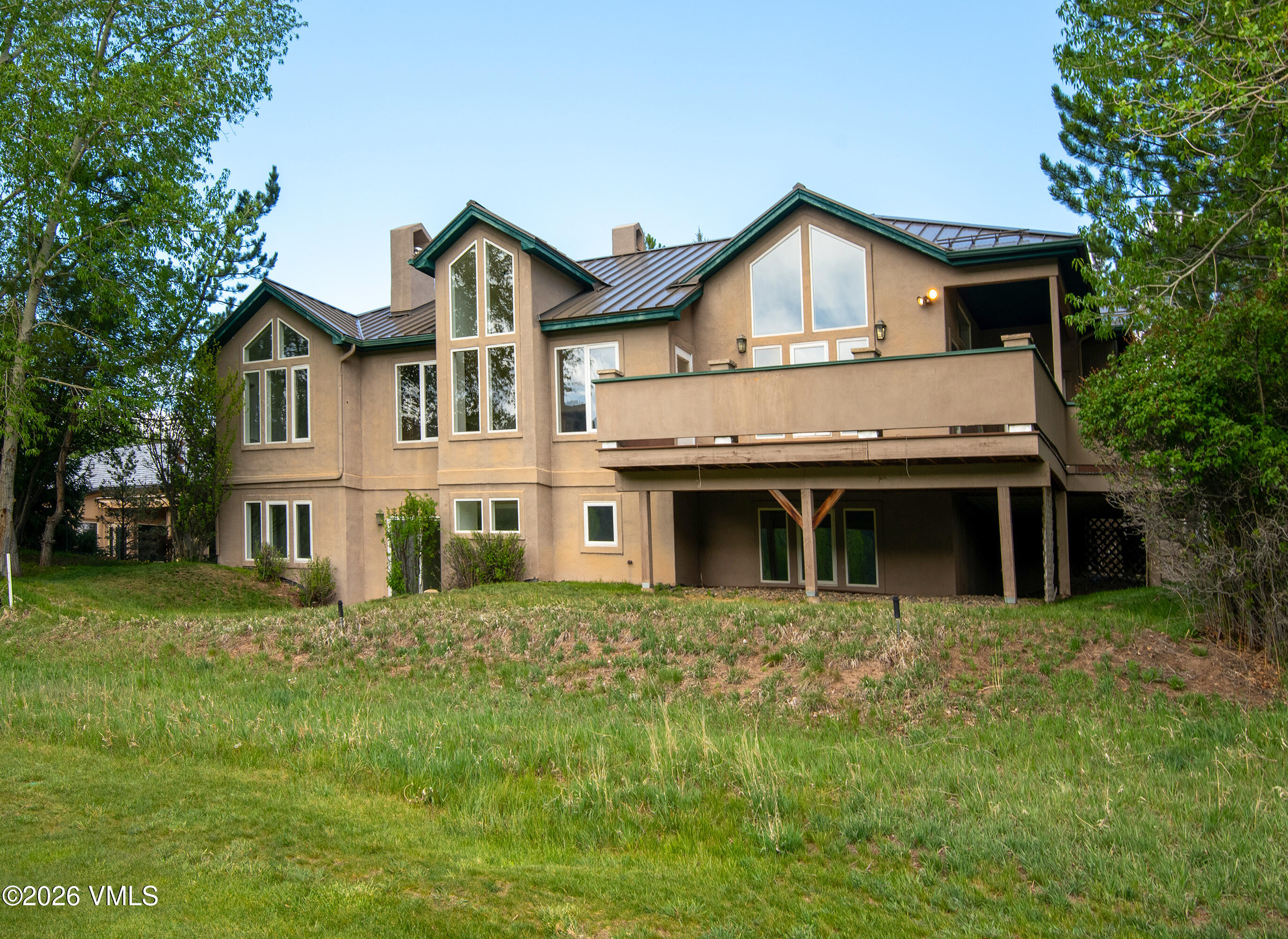 471 Rawhide Road Edwards, CO 81632 - Photo 46 of 51 a view of a house with a big yard and large trees