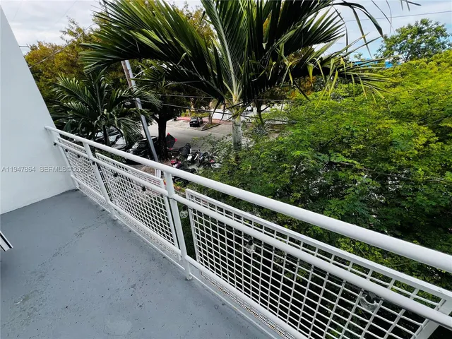 a view of backyard with plants and outdoor seating