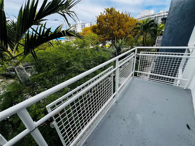 a view of balcony with wooden floor and fence