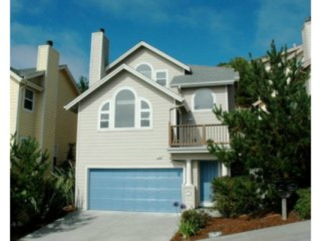 517 Monterey Road Pacifica, CA 94044 - Photo 1 of 17 a front view of a house with a garden