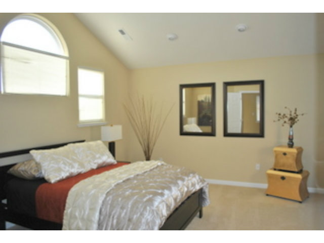 517 Monterey Road Pacifica, CA 94044 - Photo 10 of 17 a bedroom with a bed and wooden floor