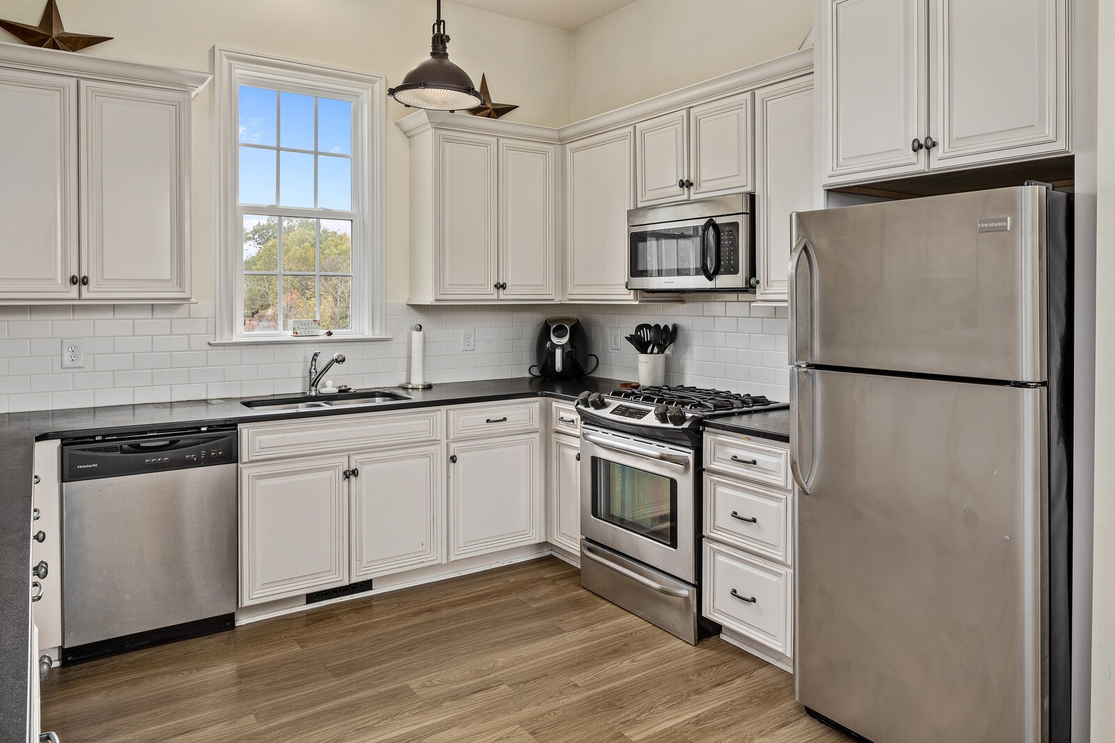 3350 Bailey Road Franklin, TN 37064 - Photo 11 of 37 a kitchen with stainless steel appliances granite countertop a refrigerator stove a sink and dishwasher with wooden floor