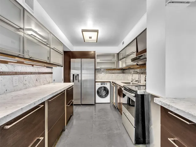a kitchen with a stove sink and cabinets
