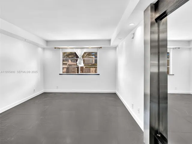 an empty room with windows and closet