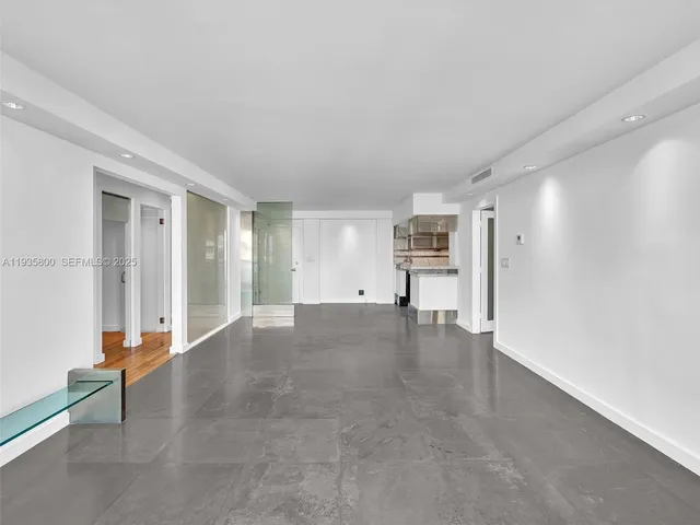a view of empty room with furniture and refrigerator