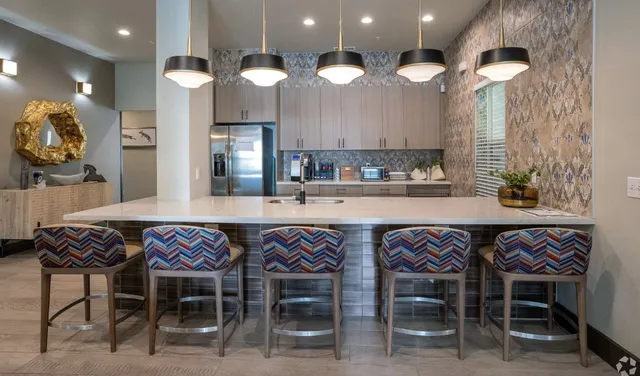 a dining area with a table and chairs