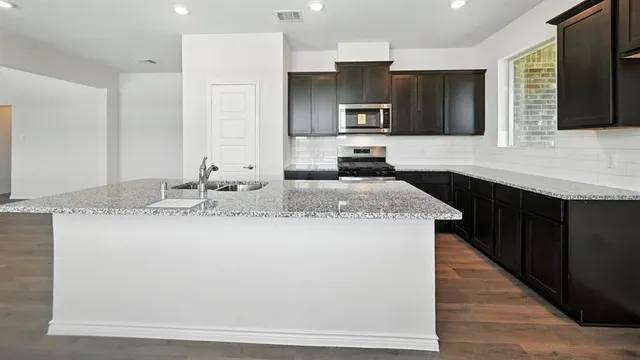 a kitchen with a wooden floor window and wooden floor