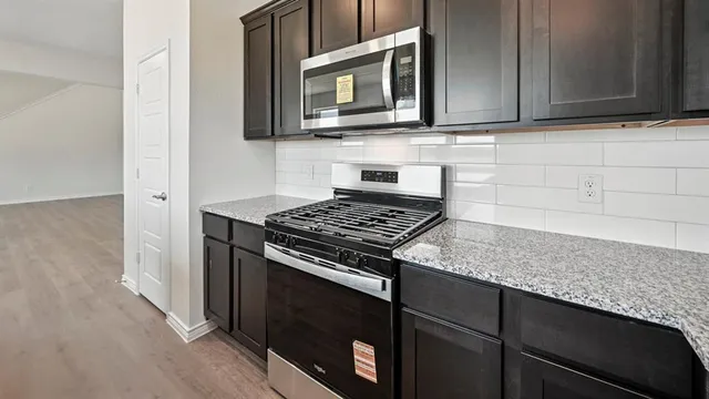 a kitchen with a sink cabinets and window