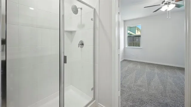 a view of a bathroom with a shower and a sink