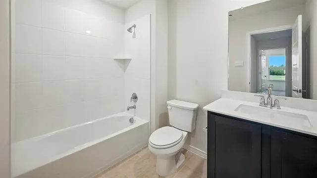 a bathroom with a toilet a sink and bathtub