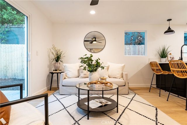 a living room with furniture and a potted plant