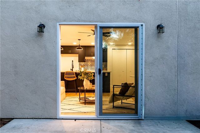 a view of a porch with a door and wooden floor