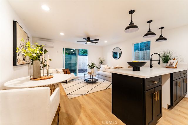 a kitchen with a sink and a clock on the wall