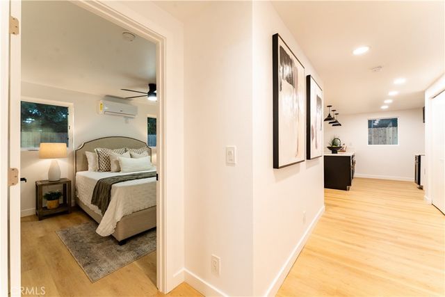 a bedroom with a bed and a view of living room