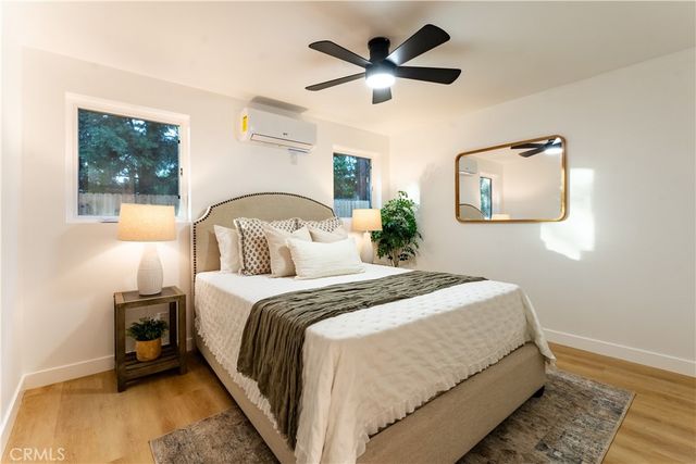 a bedroom with a bed and a large window