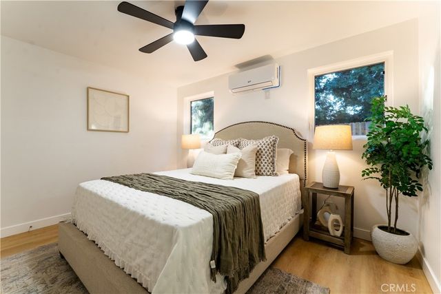 a bedroom with a bed and a potted plant