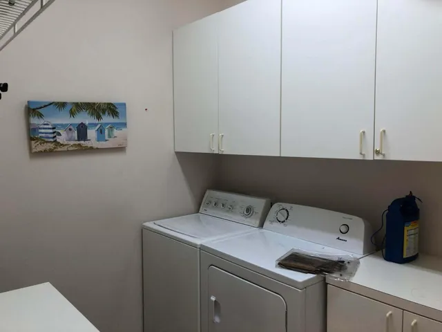 a view of a room with wooden floor and windows