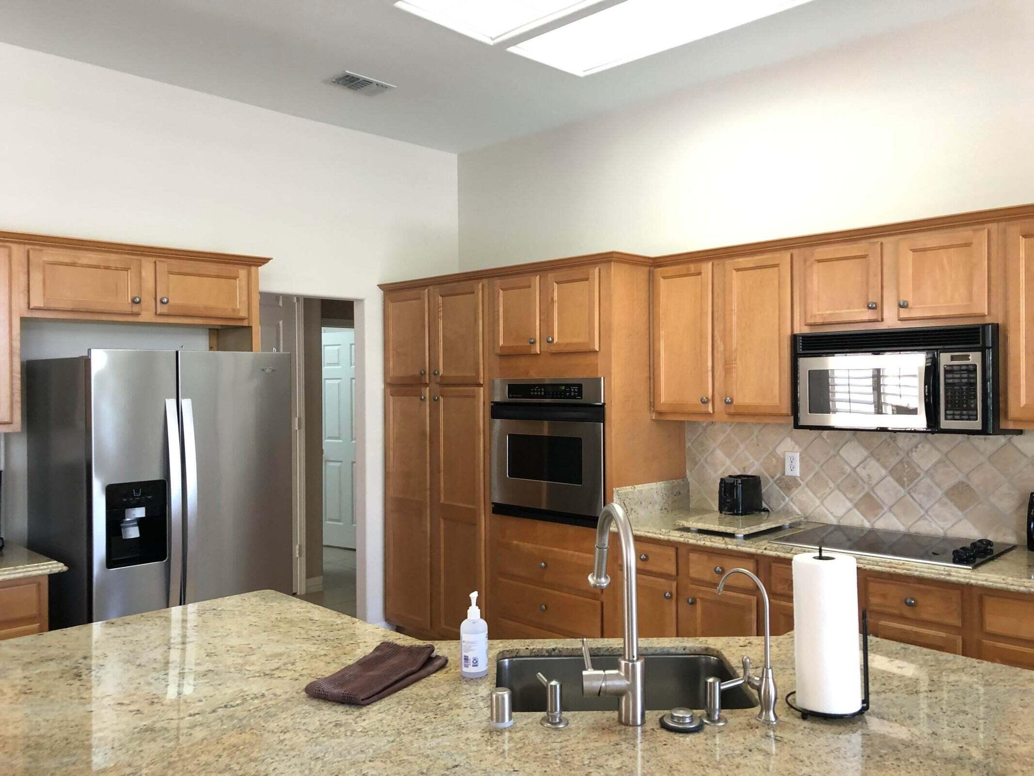 36583 Fan Palm Way Palm Desert, CA 92211 - Photo 7 of 16 a kitchen with stainless steel appliances granite countertop a refrigerator a stove and a sink