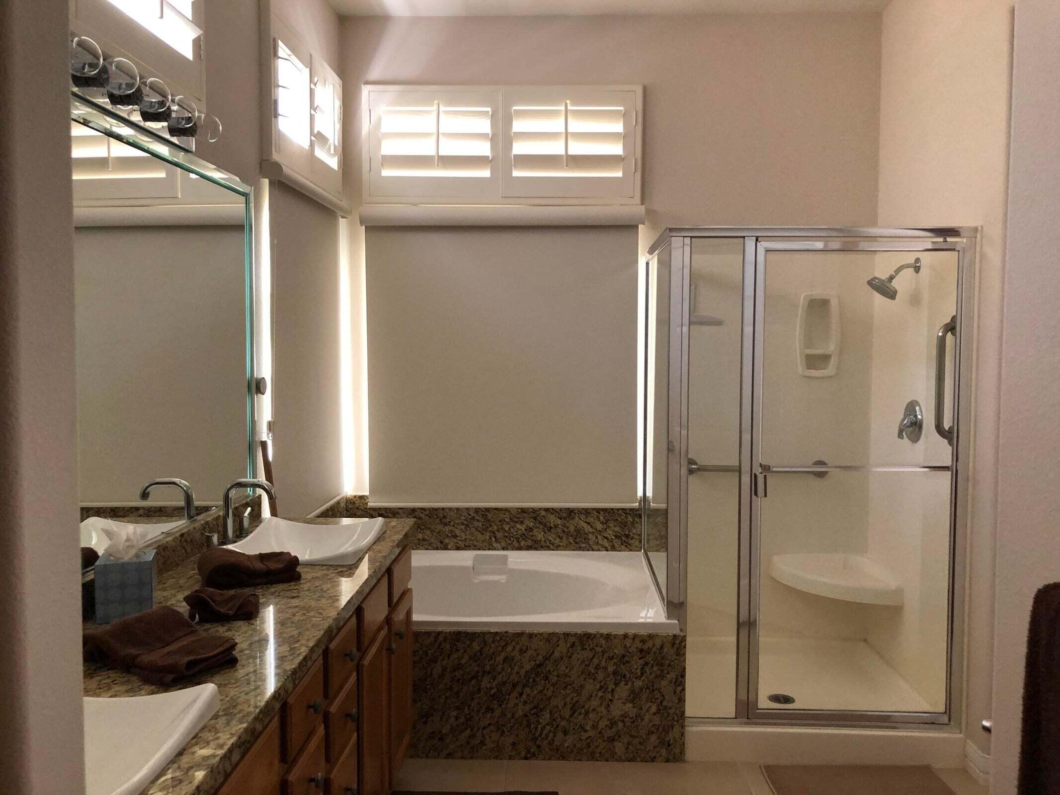 36583 Fan Palm Way Palm Desert, CA 92211 - Photo 9 of 16 a bathroom with a granite countertop sink a mirror and a shower
