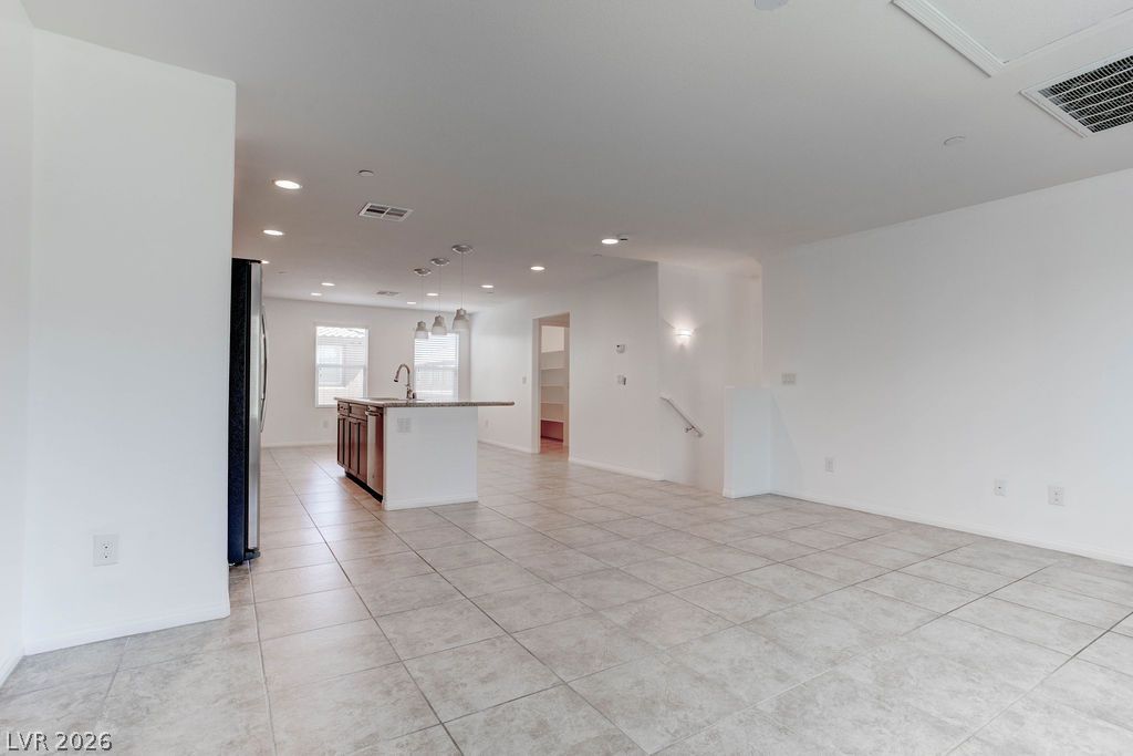 4650 Ranch House Road, Unit 47 North Las Vegas, NV 89031 - Photo 43 of 43 A contemporary open floorplan integrates the kitchen and living space, featuring recessed lighting and durable tile flooring.