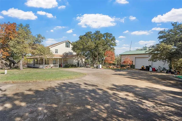 a view of a house with a yard next to a road