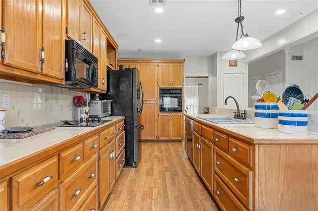 a kitchen with stainless steel appliances granite countertop a sink and cabinets