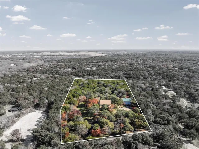 an aerial view of a residential houses with city view