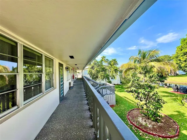 a front view of a house with a yard and lake view