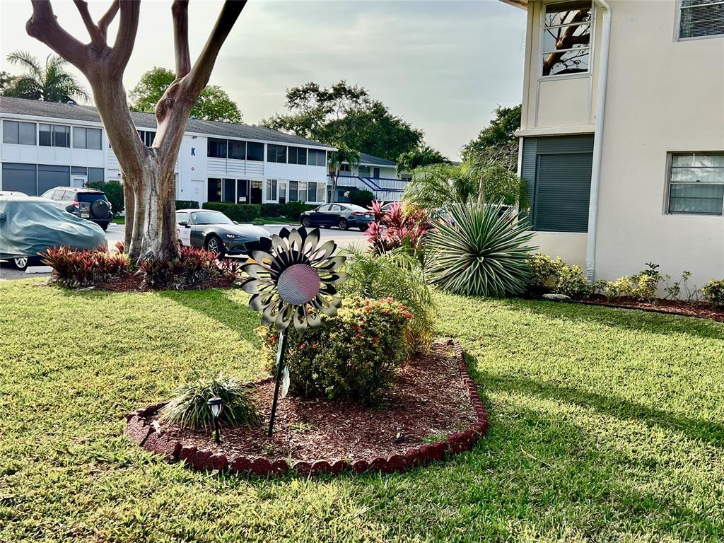 17 Markham A, Unit 17 Deerfield Beach, FL 33442 - Photo 25 of 50 a front view of a house with a yard and lake view